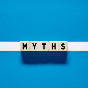 Letter tiles spelling MYTHS on a blue background.